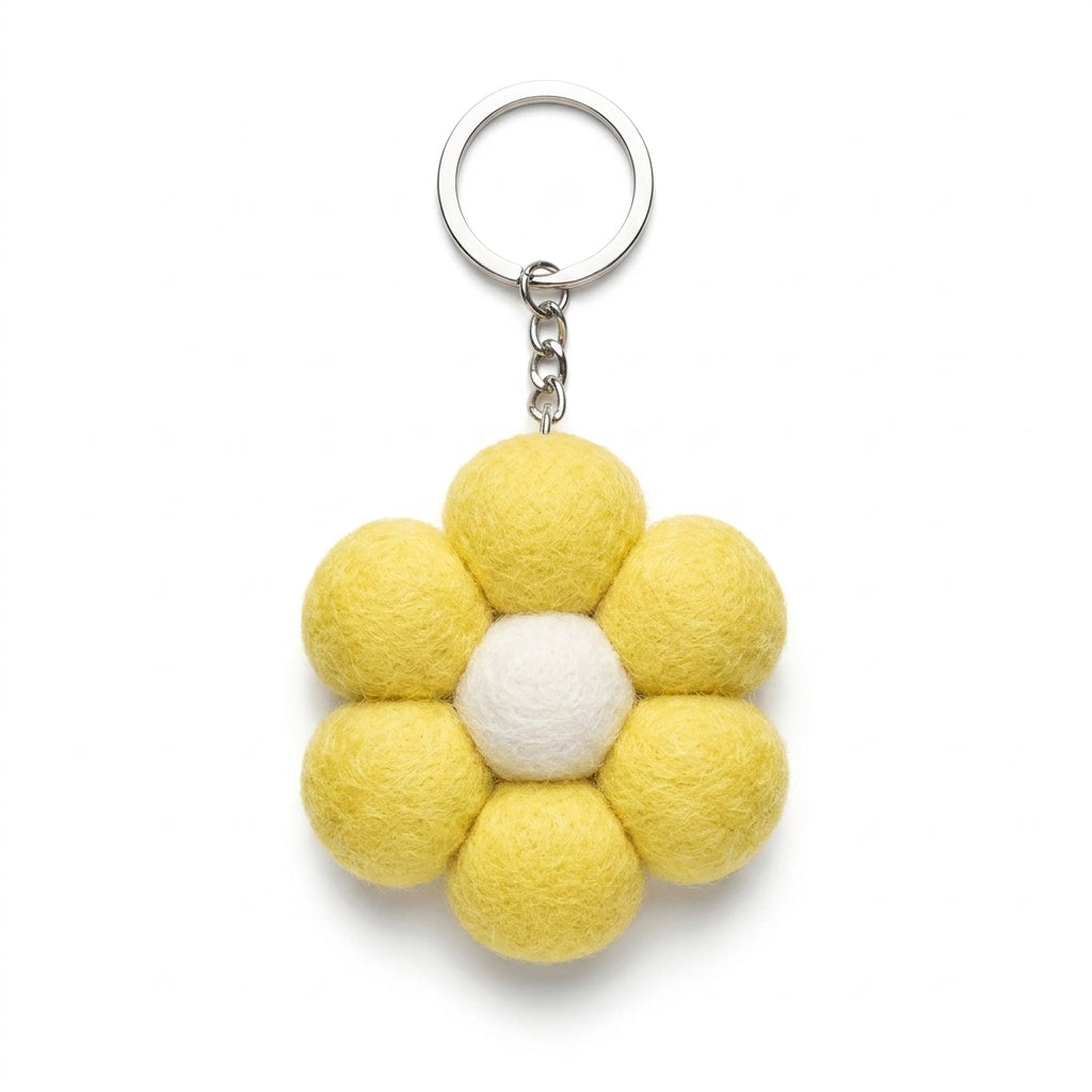 Yellow wool felt large flower keyring with white centre with a white center on a white background