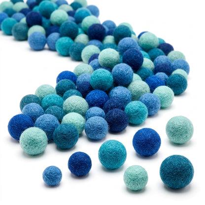 Assorted blue Assorted green Multicolored felt balls for crafts and kids diy projects on a white background