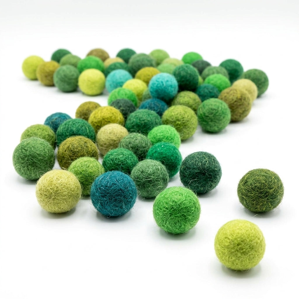 Assorted green Multicolored felt balls for crafts and kids diy projects on a white background