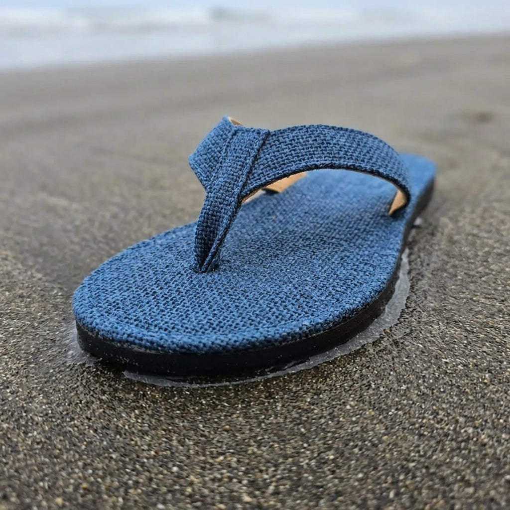Blue Dye Hemp Flip Flops  Vegan Plastic-Free Summer Sandals  Handmade Hemp Slippers on wet sand with a blurred beach background