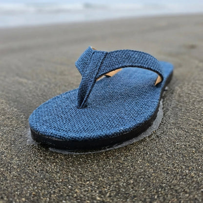 Blue Dye Hemp Flip Flops  Vegan Plastic-Free Summer Sandals  Handmade Hemp Slippers on wet sand with a blurred beach background
