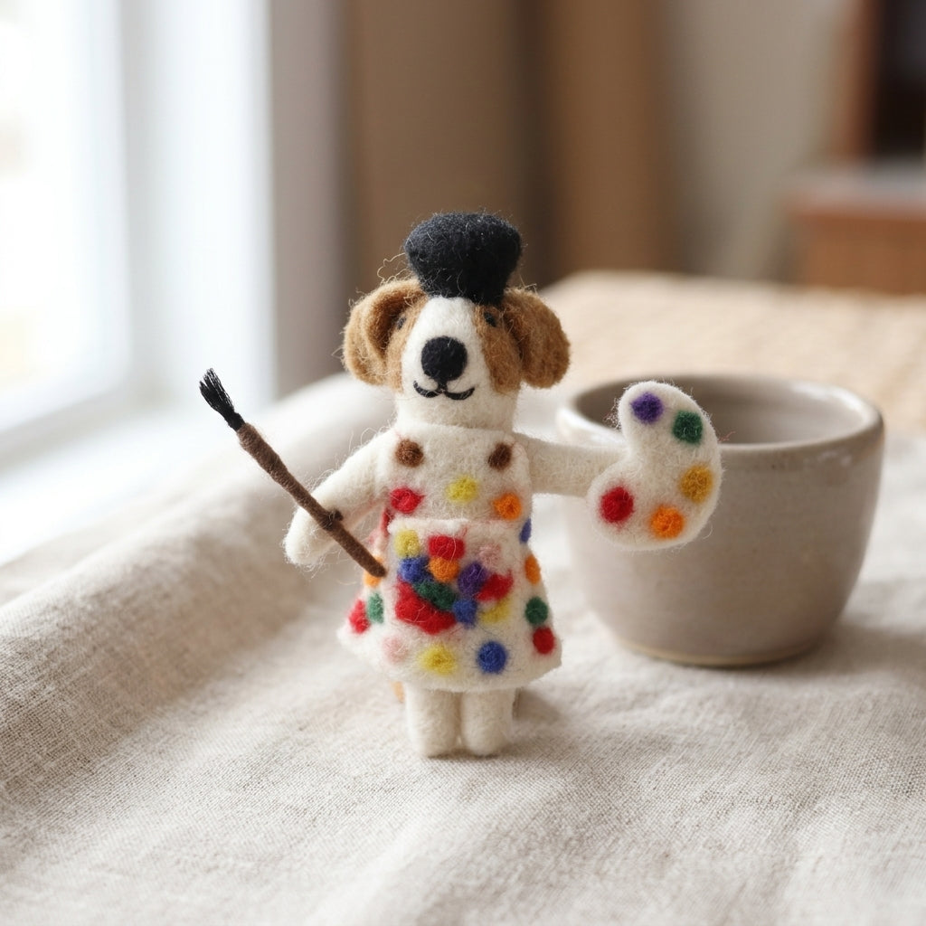 Decorative ornament of a dog in a colorful dress with artist outfit on a table