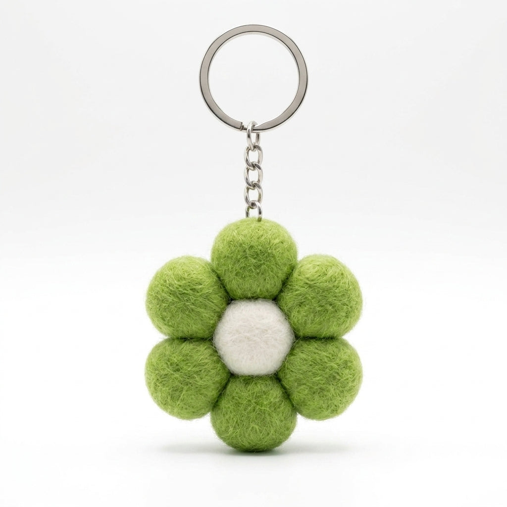Green wool felt large flower keyring with white centre on a white background