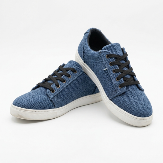 Handmade organic hemp low-top canvas sneakers in textured blue fabric with black laces and white rubber soles