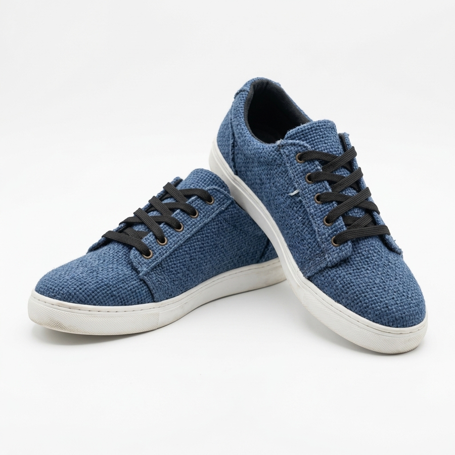 Handmade organic hemp low-top canvas sneakers in textured blue fabric with black laces and white rubber soles