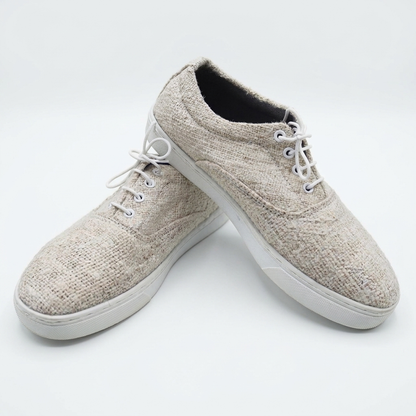 Handmade organic hemp low-top lace-up sneakers with textured woven beige uppers and white rubber soles