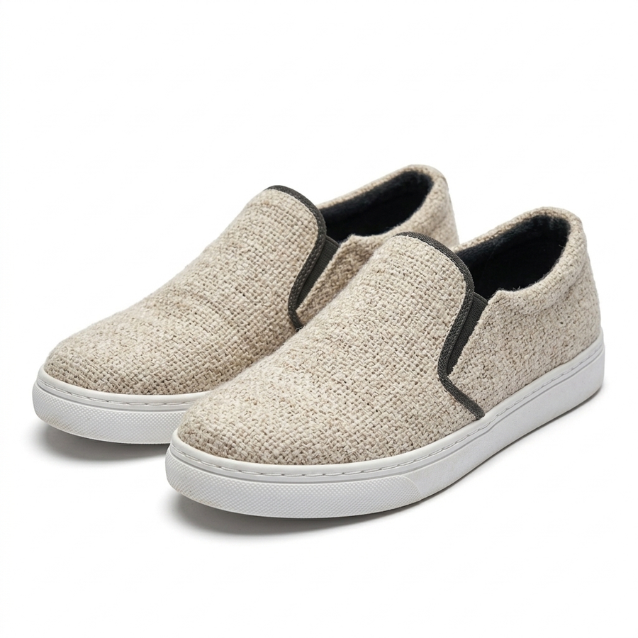 Handmade organic hemp slip-on sneakers with beige and white woven uppers, white rubber soles and black elastic trim