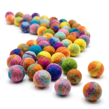 Handmade wool felt balls in assorted colours on white background