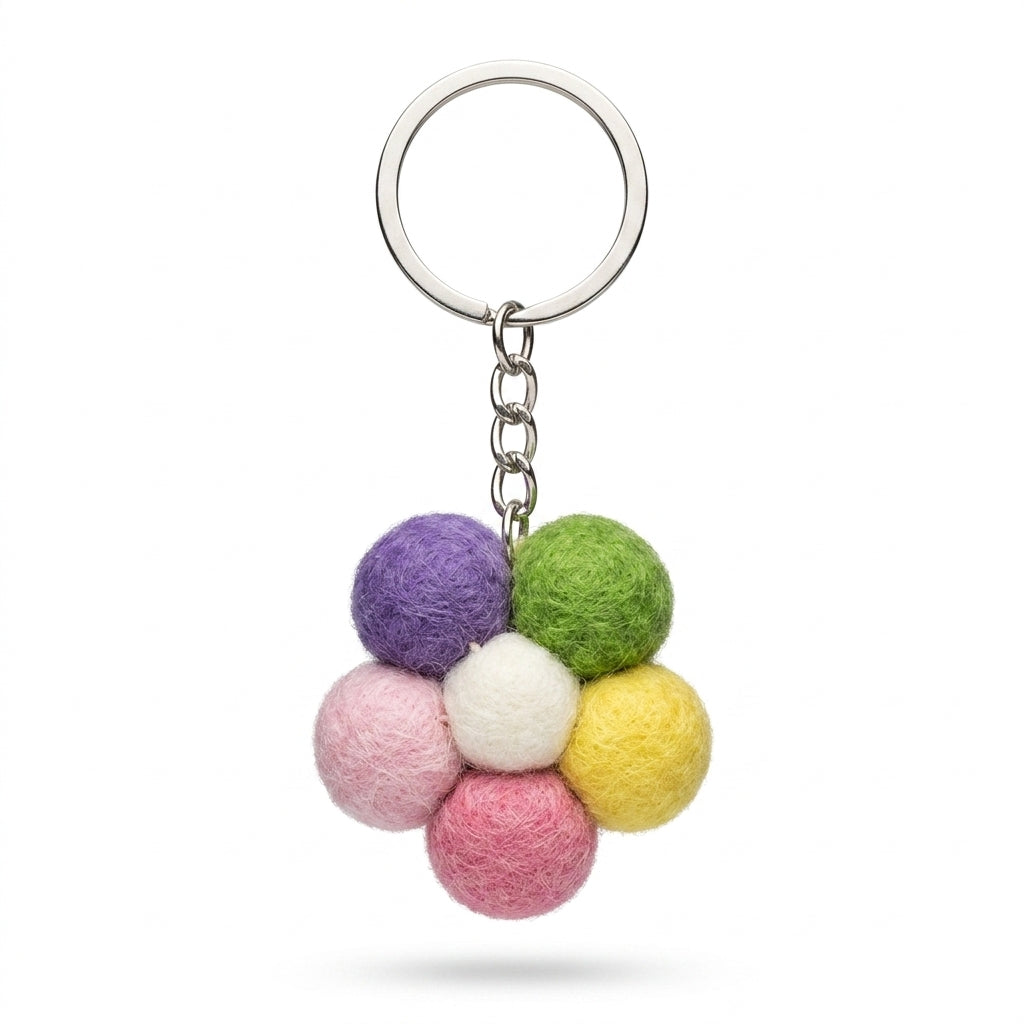 Handmade wool felt small flower keyring in pastel colours on a white background