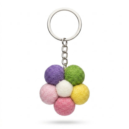 Handmade wool felt small flower keyring in pastel colours on a white background
