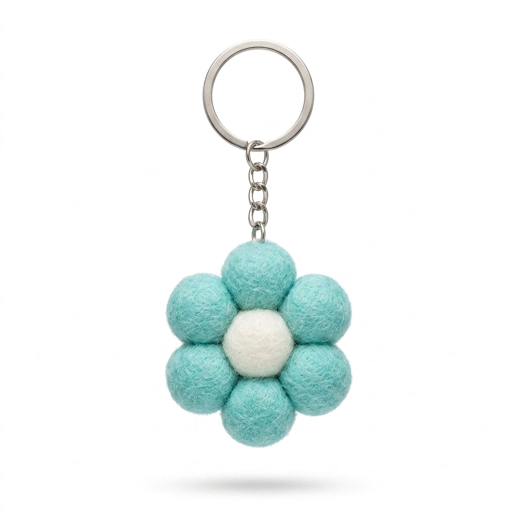 Small blue felt flower keychain with metal keyring on a white background