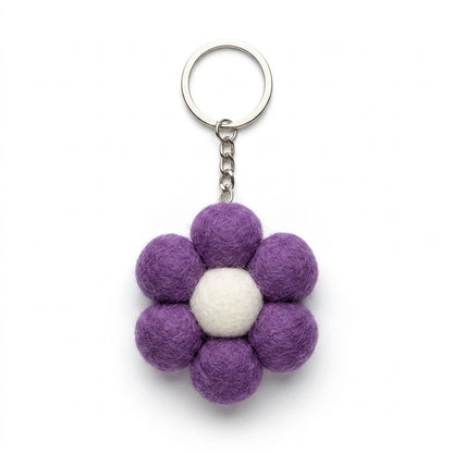 Small purple felt flower keychain with metal keyring keychain with a white center on a white background