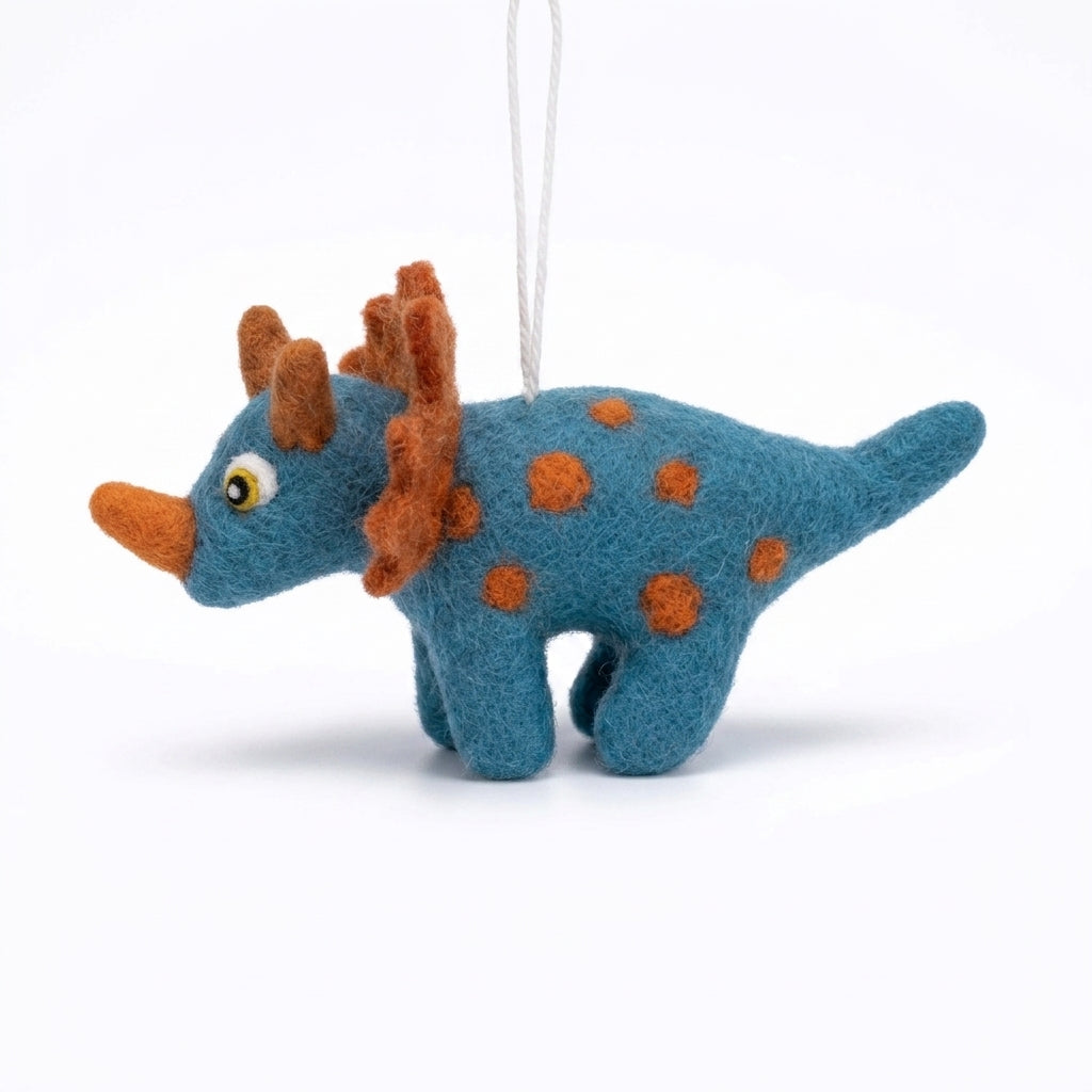 Felted dinosaur ornament with blue body and brown spikes on a white background