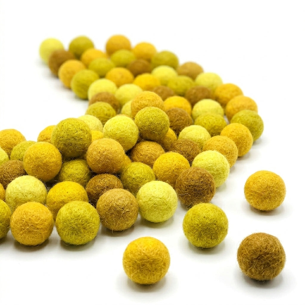 Yellow and brown felt balls on a white background