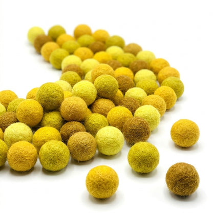Yellow and brown felt balls on a white background