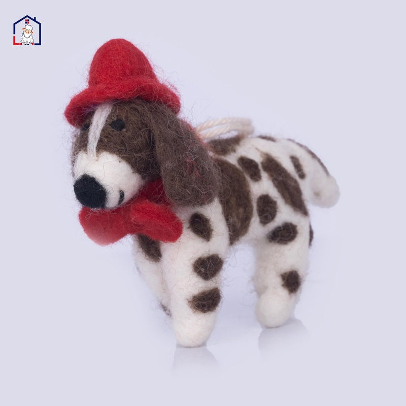 Wool felt Spaniel dog ornament wearing a red Santa hat hanging on a tree.