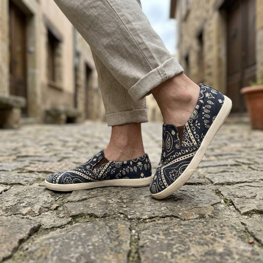 mandala patterned biodegradable hemp shoes worn on a stone pavement with a blurred background
