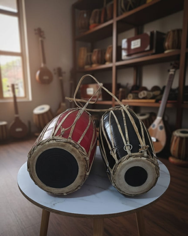 Two MADAL drums on a small round table with a music-themed room in the background.