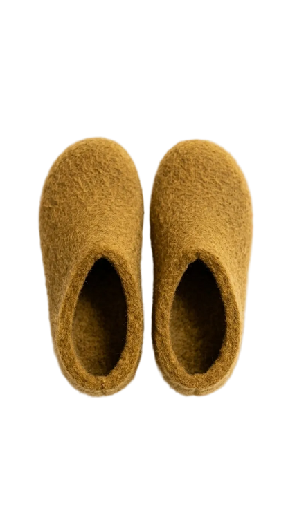 Pair of mustard yellow slippers on a white background