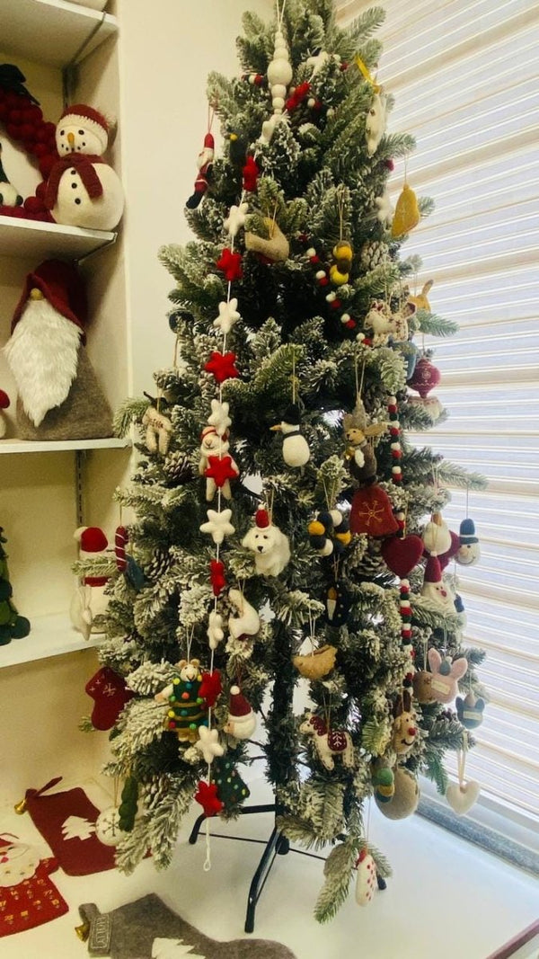 "Lucky Calico Cat felt decoration hanging on a Christmas tree."