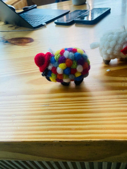 "White sheep ornament with rainbow spots - fair trade felt."