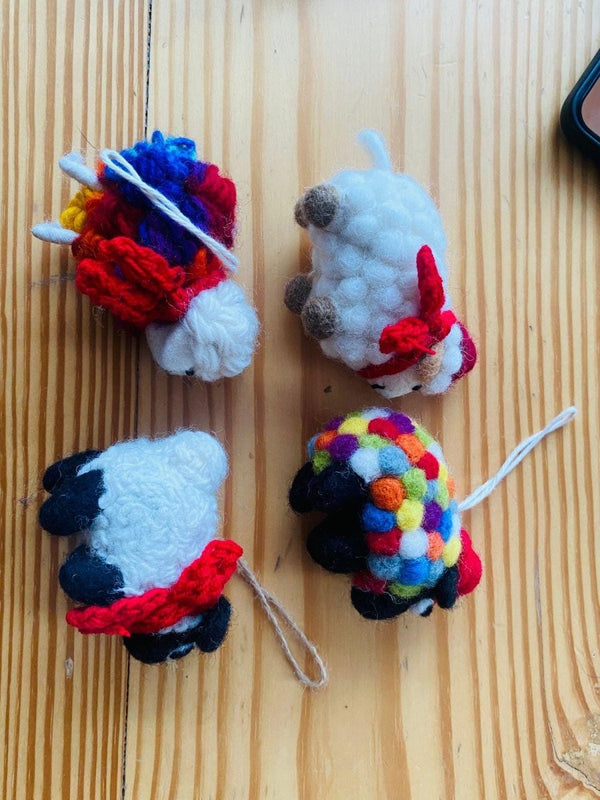 "Felt farm animal decoration hanging on a tree - sustainable wool decor."